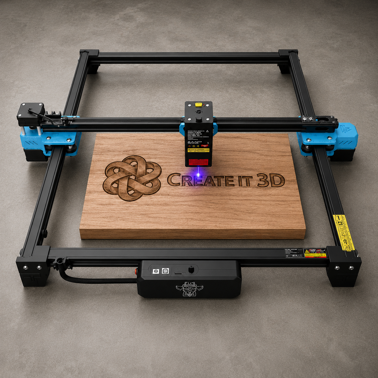 TwoTrees 5W Power Pack laser engraver on a concrete background