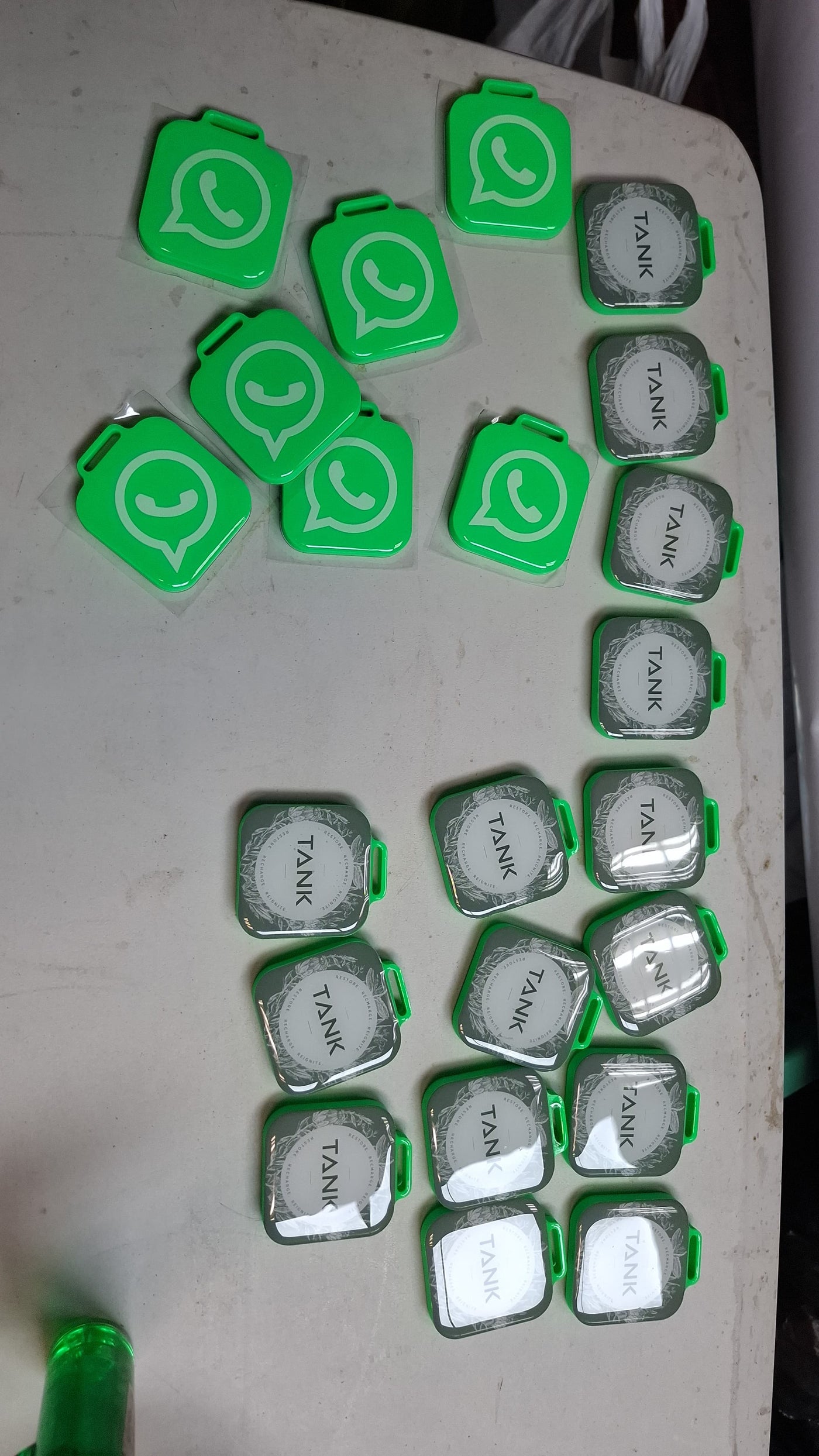 Batch of bright green custom WhatsApp NFC tags ready for production