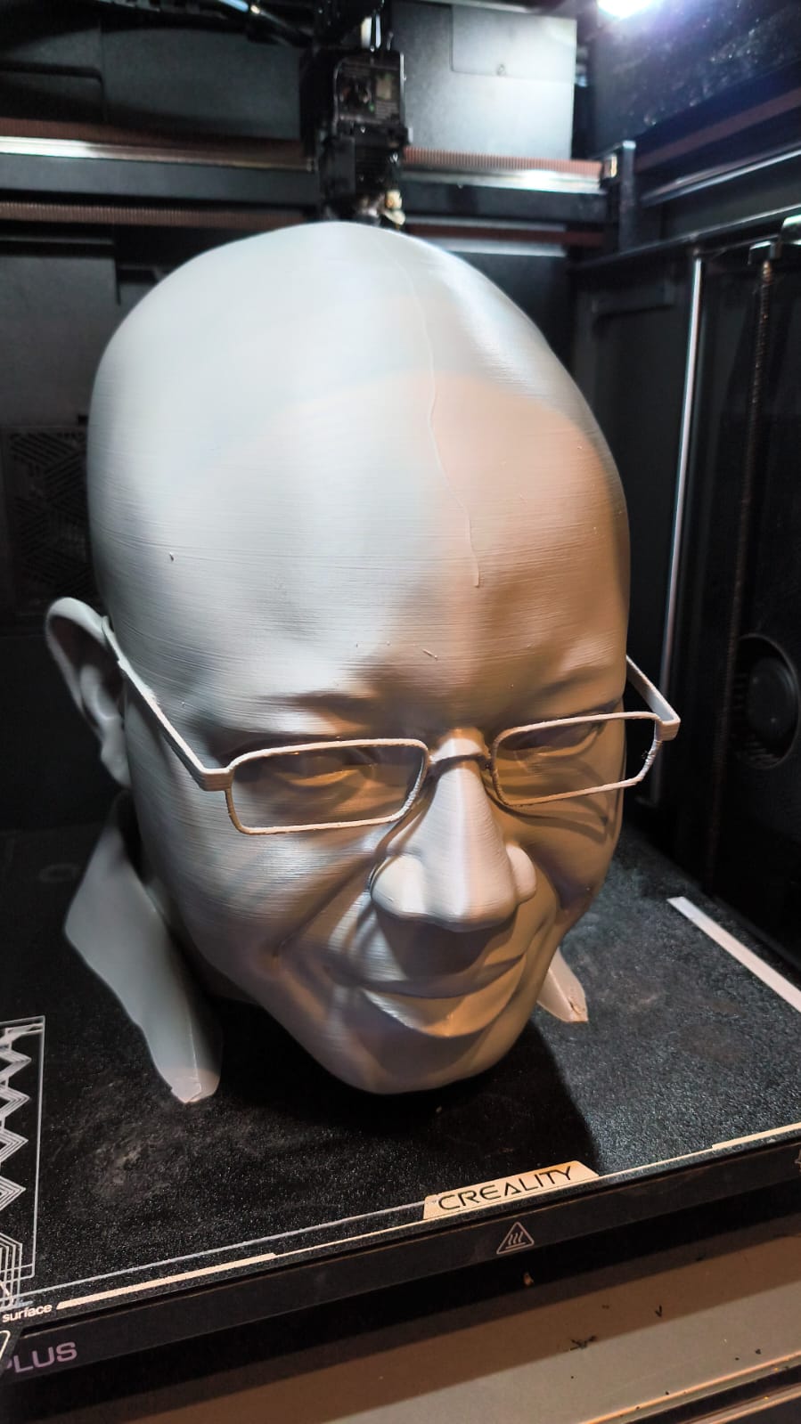 Oversized custom 3D printed portrait sculpture with glasses inside the Create it 3D studio